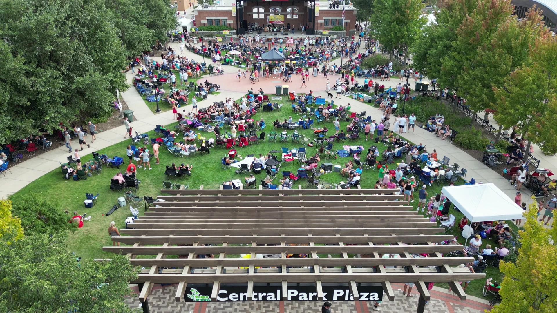 Aerial footage of Central Park Plaza, with the entrance sign and stage visible